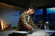 © Stella 16 - Asian man working with laptop and reading documents at home in kitchen. Man works with financial documents.