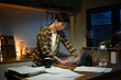 © Stella 16 - Focused man working late at night on laptop in kitchen with coffee