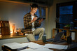 © Stella 16 - A man works late at night in a dimly lit kitchen.