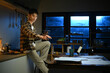 © Stella 16 - A man works late at night in a dimly lit kitchen.