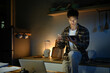 © Stella 16 - A man works late at night in a dimly lit kitchen.