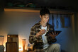 © Stella 16 - A man works late at night in a dimly lit kitchen.