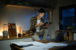 © Stella 16 - A man works late at night in a dimly lit kitchen.