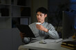 © Stella 16 - Businessman with cup of coffee working on computer in office at night