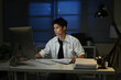 © Stella 16 - Businessman working overtime at his desk late at night