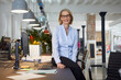 © Westend61 - Smiling businesswoman showing leadership in modern office
