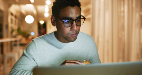 Fast food, laptop and web designer with business man in office at night for coding or programming at bokeh. Computer, creative and eating with website programmer in workplace for evening deadline