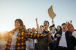 © Jacob Lund - Group of young adults expressing joy and support at a public gathering