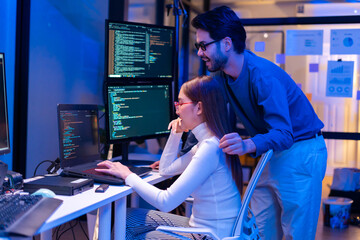 Asian software engineer or programmer team working late in development office,problem solving or algorithm of ai assistant helping for work.software developer,digital technology security concept