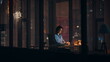 © stockbusters - Night employee working startup at dark corporate office. Hardworking woman busy