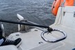 © sommersby - View from boat's transom across textured water, highlighting marine equipment like lifebuoy, safety ring, and nautical gear on grey day