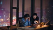 © stockbusters - Exhausted team working night looking laptop by office window. Stressed woman man
