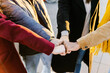 © Xavier Lorenzo - Close up group of young students stacking hands together. Millennial people celebrating together outdoor. College students teamwork stacking hand concept