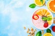 © dashtik - Colorful tropical smoothie bowl with fresh kiwi, pineapple, and granola on blue background