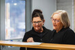© Austockphoto - Two female office workers having conversation about paperwork