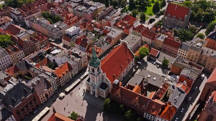 Wall Mural - Aerial cinematic orbit over Toruń Old Town square and Holy Spirit Church