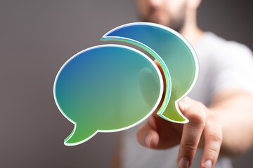 Image of a man interacting with digital speech bubbles, representing communication and connection.