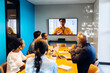 © (JLco) Julia Amaral - Team engaging in a video conference call inside a professional office setting