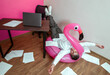 © VISTA by Westend61 - Overworked person lying on inflatable flamingo surrounded by office paperwork
