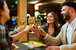 © djile - Happy friends toasting wine glasses in restaurant celebrating friendship