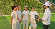 © Raushan_films - Indian asian young adult gen z woman lady group team standing coach man do sports discussion at match male guy trainer explain game strategy girls female player wear white uniform outdoor play ground