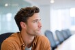 © Сергей Захаров - Thoughtful young man in modern office setting reflecting on idea