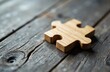 © starush - A wooden puzzle piece placed on a rustic wooden surface