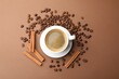 © New Africa - Cup of hot coffee, cinnamon and beans on brown background, flat lay