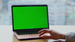 © stockbusters - Hands swiping chromakey computer touchpad at cityscape remote workplace closeup