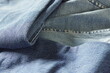 © tanyatorgonskaya - Close up of vintage denim fabric background with faded blue tones. Retro jeans material for nostalgic fashion trends, secondhand clothing revival, ethical textiles and timeless classic style concepts.