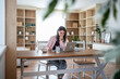 © Migma_Agency - Focused female freelancer working from home office on laptop