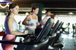 © JackF - Young woman in sportswear training on treadmill in gym