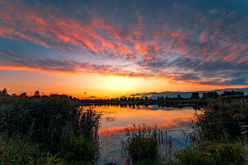 Wall Mural - Summer sunset with beautiful sky over the lake.