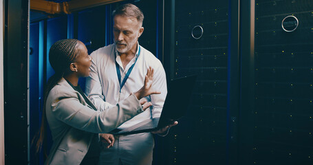 People, laptop and server room with cyber security, maintenance and inspection with engineering. IT specialist, pc and teamwork with programming, system solution or feedback for hardware upgrade