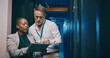 © peopleimages.com - Tablet, team and people in data center for cybersecurity, system upgrade or IT. Discussion, tech and engineer in server room for network diagnostics, planning maintenance or ai training with mentor