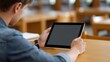 © M - 'Overhead View of Female Designer Holding Tablet with Blank Screen for App Mockup and Remote Work Concept'