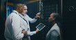 © peopleimages.com - Server room, training and manager with team on tablet for cybersecurity, diagnostics test and maintenance. IT service, meeting and worker with boss for network, online database and technical support