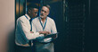 © peopleimages.com - Server room, talking and people on tablet for IT support, database backup and cybersecurity. Meeting, hardware and workers on digital tech for system maintenance, diagnostics and technical service