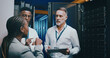 © peopleimages.com - Server room, training and people on tablet for cybersecurity, diagnostics test or maintenance. IT team, meeting and workers with boss on digital tech for network, online database or technical support