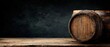 © oksa_studio - Background image of old wooden barrels resting on a table in a dark cellar, ideal for promoting alcoholic beverages