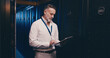 © peopleimages.com - Tablet, reading and technician or man in server room for cyber security, software update and database system. Programmer, developer and cybersecurity with mature person in data center as engineer