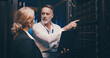 © peopleimages.com - Laptop, pointing and team of engineers in server room for technical support, database or cybersecurity. Computer, teamwork and people with system upgrade in data center for network programming.
