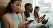 © peopleimages.com - Waiting room, phone and business woman for research, job interview and opportunity in office. Line, coffee and people with cellphone for chatting on mobile app for recruitment process and update