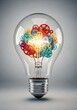 © hsa1 - Light bulb filled with colorful gears representing a creative idea and innovation, against a grey background