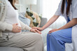 © Kawee - Close up of pregnant woman consult with doctor at maternal health center.