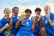 © Rido - Young football team holding trophy after victory