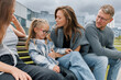 © makedonski2015 - Family concept. Dad and mom with two daughters sitting on a bench
