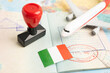 © Warawan - Italy passport with approved stamp on document for tourism to immigration at airport in country.