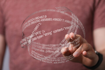 Close-up of a hand interacting with a digital hologram displaying lines of code.