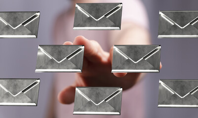 Metallic email icons hover above a hand, symbolizing digital communication and inbox management.
